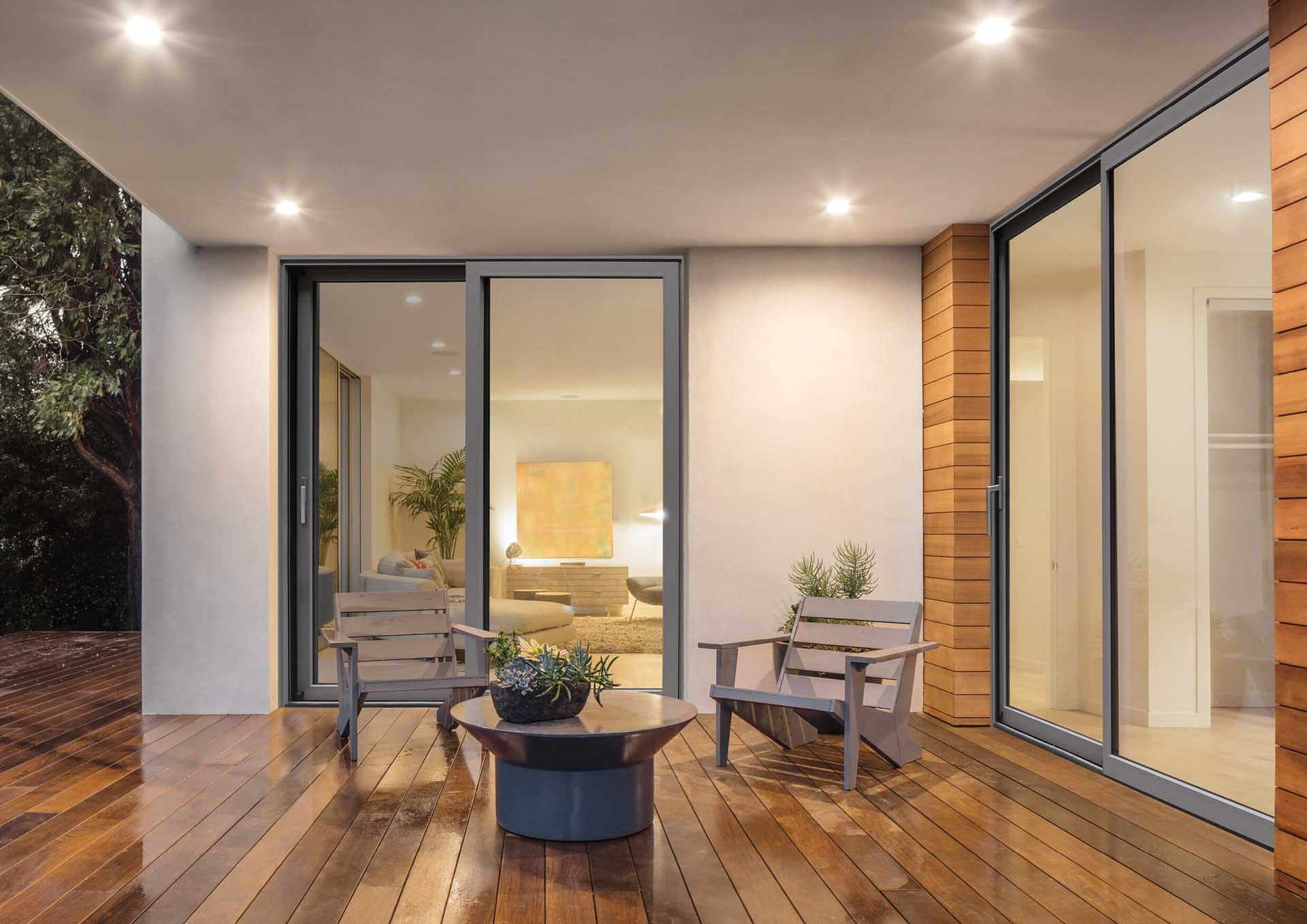 Internal aluminium sliding doors in a well lit room with wooden floors