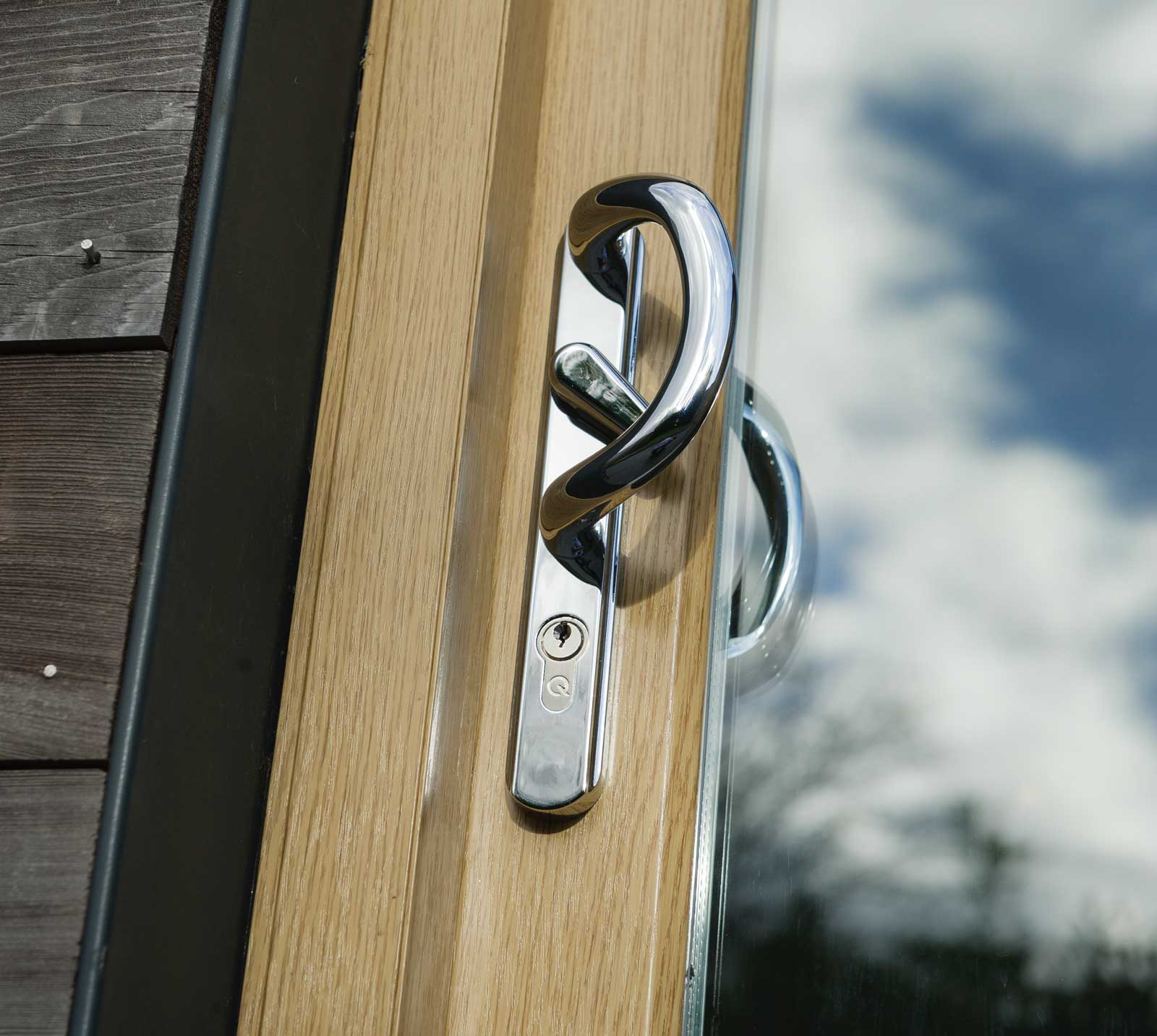 close up external shot of woodgrain foiled upvc patio sliding doors handle