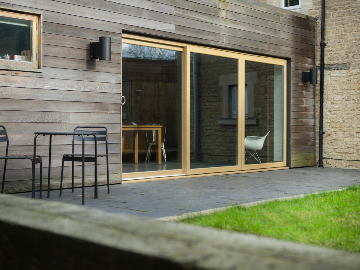 Energy efficient sustainably made uPVC patio sliding doors in a light brown woodgrain foil